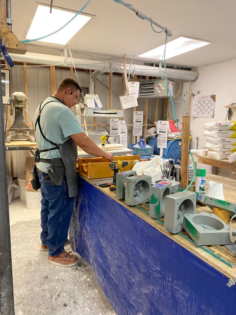 Employee working on molds in IPI Inc. Headquarters